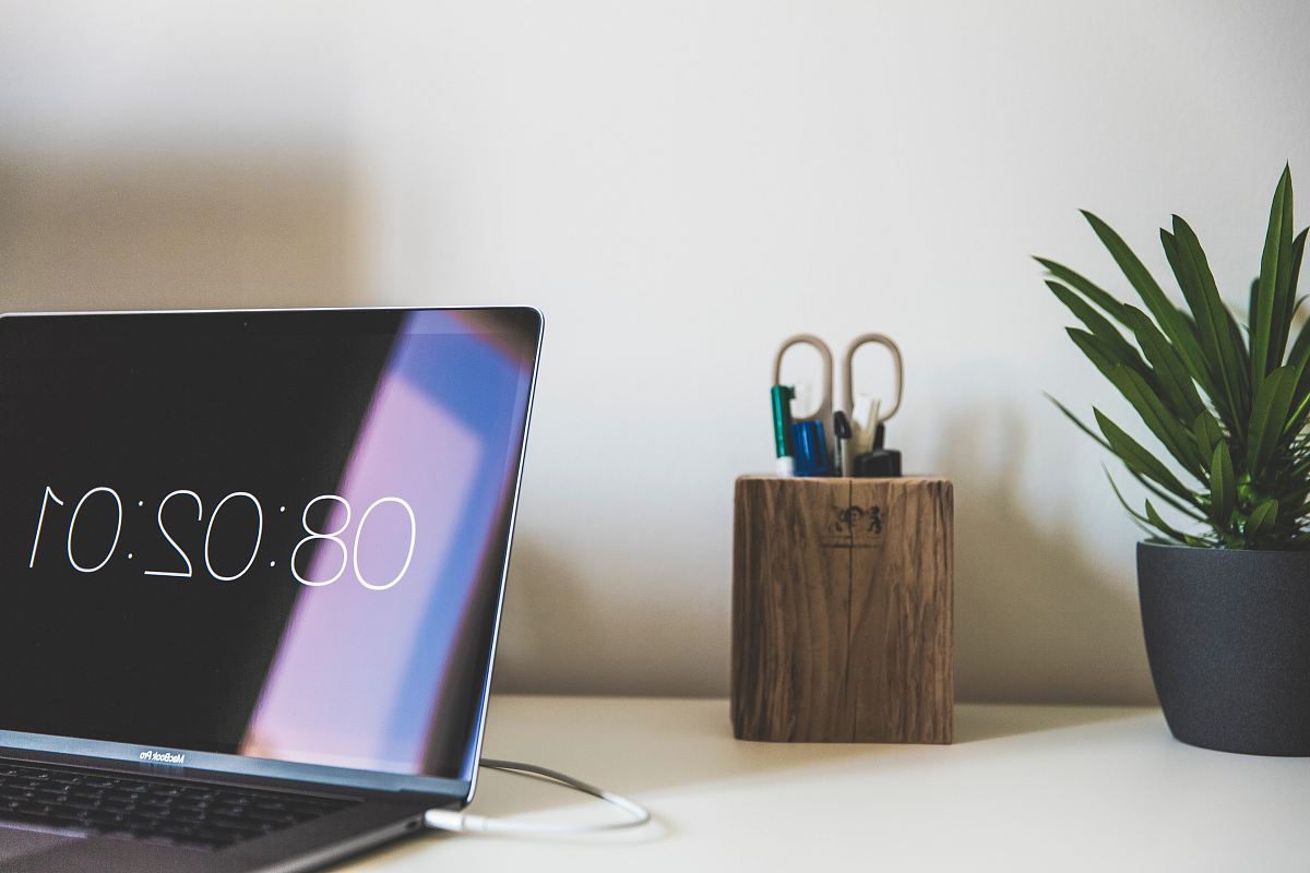 MacBook Air near brown wooden desktop organizer